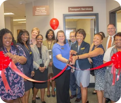 Chatham County, GA Superior Court Clerk, Democrat Tammie Mosley, is featured in the Savannah Morning News celebrating passport services and office grand opening and ribbon cutting with various Superior Court Clerk office employees.